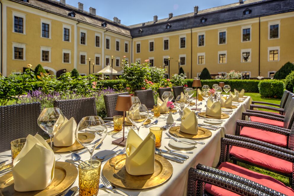 A beautifully set table for a celebration in the castle garden of the Culinaro Restaurant in Salzkammergut