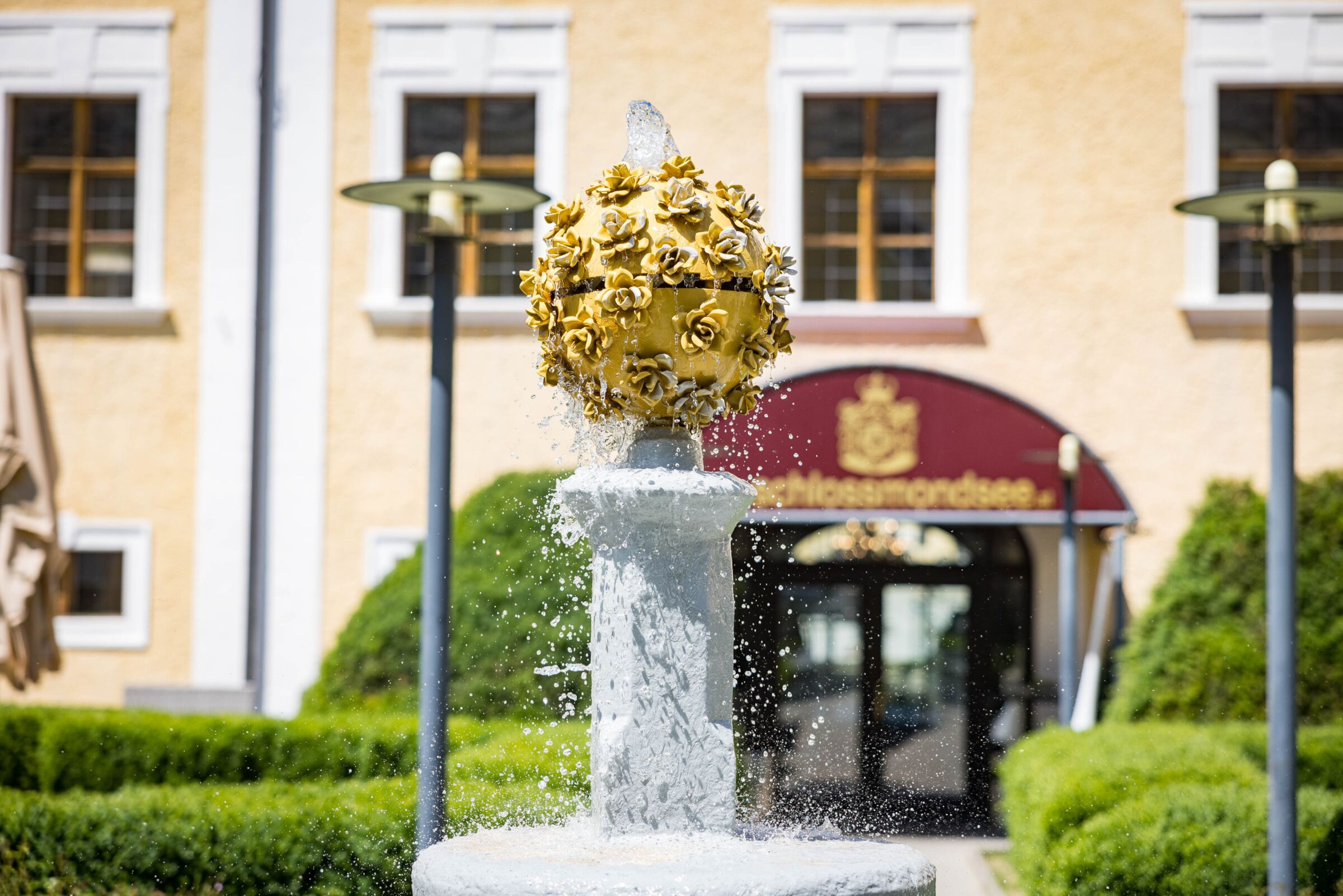 Castle fountain with an elegant design in the castle garden of Mondsee Castle - a historical highlight in a green setting